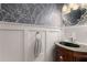Chic powder room with decorative wallpaper, stylish mirror, and elegant fixtures offers a touch of luxury at 202 Carrington Estates Ct, Woodstock, GA 30188