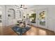 Bright and cozy sitting area with large windows, hardwood floors, and access to the outside patio at 202 Carrington Estates Ct, Woodstock, GA 30188