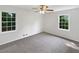 Bright bedroom features bright windows, neutral tones, and a ceiling fan at 2390 Century Ln, Snellville, GA 30039