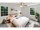 Staged bedroom features bright windows, neutral tones, and a ceiling fan at 2390 Century Ln, Snellville, GA 30039
