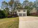 Charming two-story home with a deck, two-car garage, and a spacious driveway at 2390 Century Ln, Snellville, GA 30039