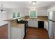 Efficient kitchen featuring stainless steel appliances, light cabinets, and wood-look floors at 2390 Century Ln, Snellville, GA 30039