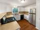Efficient kitchen featuring stainless steel appliances, light cabinets, and wood-look floors at 2390 Century Ln, Snellville, GA 30039