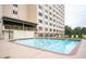 Outdoor pool area with lounge chairs and high-rise building backdrop at 2479 Ne Peachtree Ne Rd # 1112, Atlanta, GA 30305