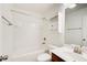 Well-lit bathroom with a bathtub, toilet, sink and vanity, and storage with a white cabinet above at 3365 Vintage Se Cir, Smyrna, GA 30080