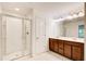 Modern bathroom featuring a glass-enclosed shower, double vanity with brown cabinets, and tiled floors at 3365 Vintage Se Cir, Smyrna, GA 30080