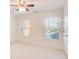 Sunlit bedroom with large windows, neutral carpet, and a ceiling fan adding to the room's appeal at 3365 Vintage Se Cir, Smyrna, GA 30080