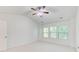 Bright, carpeted bedroom with three windows and a ceiling fan at 3365 Vintage Se Cir, Smyrna, GA 30080