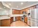 Modern kitchen featuring stainless steel appliances, wooden cabinets, and granite countertops at 3365 Vintage Se Cir, Smyrna, GA 30080