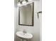 Close-up view of a powder room featuring a pedestal sink and decorative mirror at 3365 Vintage Se Cir, Smyrna, GA 30080