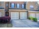 Attractive brick townhome featuring a two-car garage and well-maintained landscaping at 3365 Vintage Se Cir, Smyrna, GA 30080