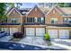 Charming brick townhome featuring a one car garage and landscaped front yard at 3365 Vintage Se Cir, Smyrna, GA 30080