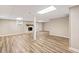 Large finished basement featuring a fireplace and wood-look flooring at 3839 Rosedale Ln, Douglasville, GA 30135