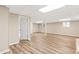 Spacious finished basement with wood-look flooring and neutral walls at 3839 Rosedale Ln, Douglasville, GA 30135