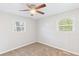 Bedroom with a ceiling fan, two windows, and carpeting at 3839 Rosedale Ln, Douglasville, GA 30135