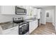 Modern kitchen with white cabinetry, stainless steel appliances, and sleek countertops at 3839 Rosedale Ln, Douglasville, GA 30135