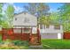 Two story home with a backyard featuring a wooden fence and deck with stairs to the yard at 484 Aberdeen Dr, Stonecrest, GA 30083
