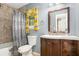 Bathroom featuring a tiled shower with curtain, modern vanity, mirror, and toilet at 484 Aberdeen Dr, Stonecrest, GA 30083