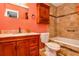 Bathroom boasts a tiled wall, wooden vanity and cabinet, and a shower-tub combination at 484 Aberdeen Dr, Stonecrest, GA 30083