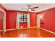 Bright bedroom featuring hardwood floors, a ceiling fan and a window with light drapes at 484 Aberdeen Dr, Stonecrest, GA 30083