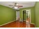 Bedroom with hardwood floors, closet with mirrored doors, and a window with natural light at 484 Aberdeen Dr, Stonecrest, GA 30083