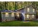 Two-story house featuring grass, trees, a porch, and stone accents on the bottom half at 484 Aberdeen Dr, Stonecrest, GA 30083