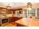 Modern kitchen featuring granite countertops, stainless steel appliances, and a stylish light fixture above the breakfast bar at 484 Aberdeen Dr, Stonecrest, GA 30083