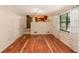 Spacious living room with wood flooring, an open view to the kitchen, and a doorway to another area of the home at 484 Aberdeen Dr, Stonecrest, GA 30083