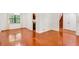 Spacious living area featuring hardwood floors, white walls, and staircase leading to the upper level at 484 Aberdeen Dr, Stonecrest, GA 30083