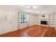 Cozy living room featuring hardwood floors, a decorative fireplace, and built-in shelving at 484 Aberdeen Dr, Stonecrest, GA 30083