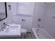 Well-lit bathroom featuring a sink, toilet, bathtub, and window with blinds at 110 Ridge Se Ct, Mableton, GA 30126