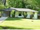 Charming renovated single-story home featuring a carport and freshly manicured lawn at 110 Ridge Se Ct, Mableton, GA 30126