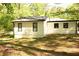 Side view of home featuring white siding, black trim, and a well-maintained lawn at 110 Ridge Se Ct, Mableton, GA 30126