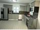 Modern kitchen with stainless appliances, granite countertops, tile backsplash, and light gray cabinetry at 110 Ridge Se Ct, Mableton, GA 30126