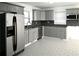 Updated kitchen with modern cabinets, granite countertops, stainless steel appliances, and tile flooring at 110 Ridge Se Ct, Mableton, GA 30126