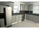 Updated kitchen with modern cabinets, granite countertops, stainless steel appliances, and tile backsplash at 110 Ridge Se Ct, Mableton, GA 30126