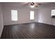 Open living room with gray wood-look flooring and many windows at 110 Ridge Se Ct, Mableton, GA 30126