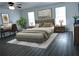 A serene main bedroom with a ceiling fan, natural light, hardwood flooring, and neutral decor at 110 Ridge Se Ct, Mableton, GA 30126