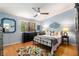 Cozy bedroom with wood floors, metal bed frame, dark wood dresser, and vibrant colorful rug at 2002 Cedar Chase Ne Ln, Atlanta, GA 30324