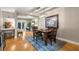 Charming dining area with hardwood floors, a stylish chandelier, and views of the outdoors through French doors at 2002 Cedar Chase Ne Ln, Atlanta, GA 30324