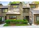 Inviting townhouse with a landscaped front yard, featuring a charming facade and natural surroundings in a desirable neighborhood at 2002 Cedar Chase Ne Ln, Atlanta, GA 30324