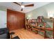 Versatile home office featuring hardwood floors, wooden bookcase, and functional cabinet for storage at 2002 Cedar Chase Ne Ln, Atlanta, GA 30324