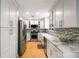 Modern kitchen with white cabinetry, stainless steel appliances, marble countertops, and stylish backsplash for cooking enjoyment at 2002 Cedar Chase Ne Ln, Atlanta, GA 30324