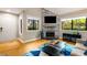 Cozy living room with fireplace, hardwood floors, large windows providing abundant natural light, and inviting atmosphere at 2002 Cedar Chase Ne Ln, Atlanta, GA 30324