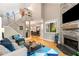 Open living room features a fireplace, hardwood floors, a modern staircase, and large windows for natural light and a view at 2002 Cedar Chase Ne Ln, Atlanta, GA 30324
