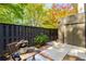 Back patio area featuring wood privacy fence, patio dining set and lush landscaping at 2002 Cedar Chase Ne Ln, Atlanta, GA 30324