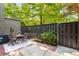 Private patio area with wood fence, bistro table, and mature landscaping at 2002 Cedar Chase Ne Ln, Atlanta, GA 30324