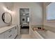 Elegant bathroom featuring double vanity, soaking tub and access to main bedroom at 3003 Evanshire Ave, Duluth, GA 30096