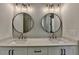 Modern bathroom featuring double vanity with round mirrors and marble countertops at 3003 Evanshire Ave, Duluth, GA 30096