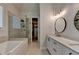 Modern bathroom featuring a soaking tub, glass shower, dual vanities and a walk-in closet at 3003 Evanshire Ave, Duluth, GA 30096